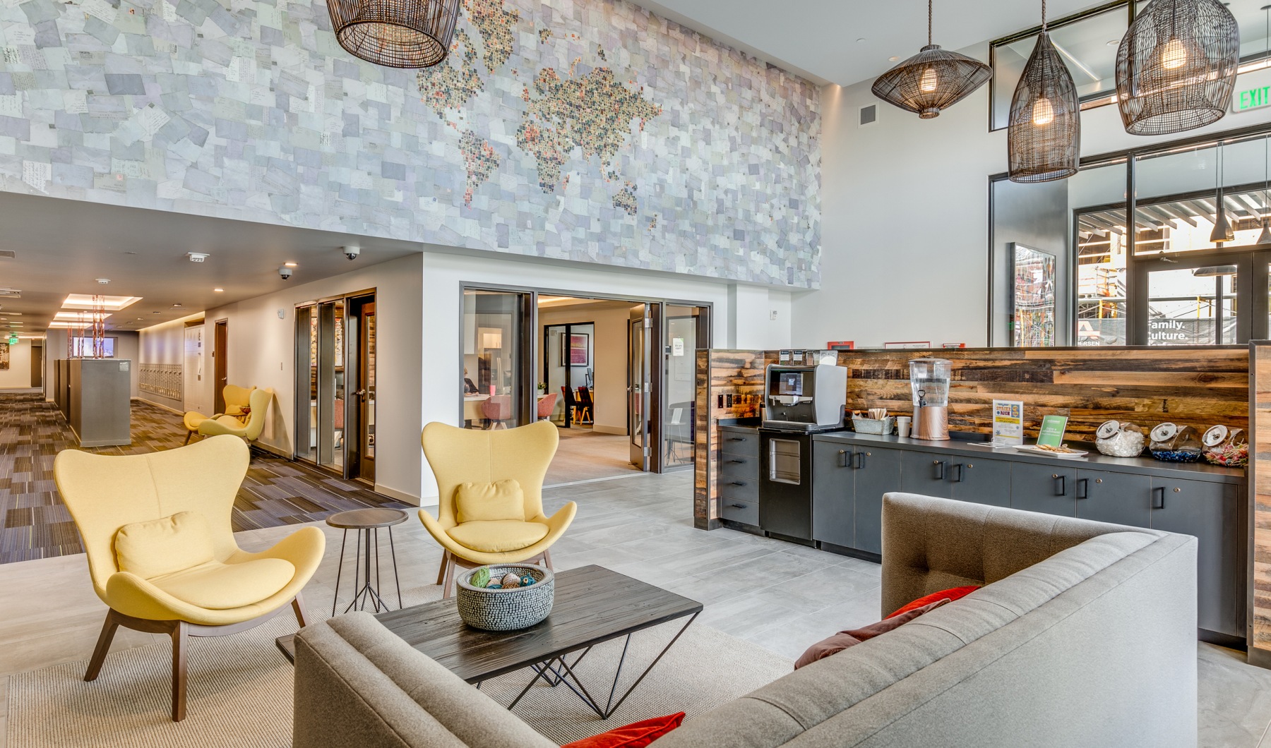 Embrace All That Batik Offers lobby with hanging lights and mosaic wall