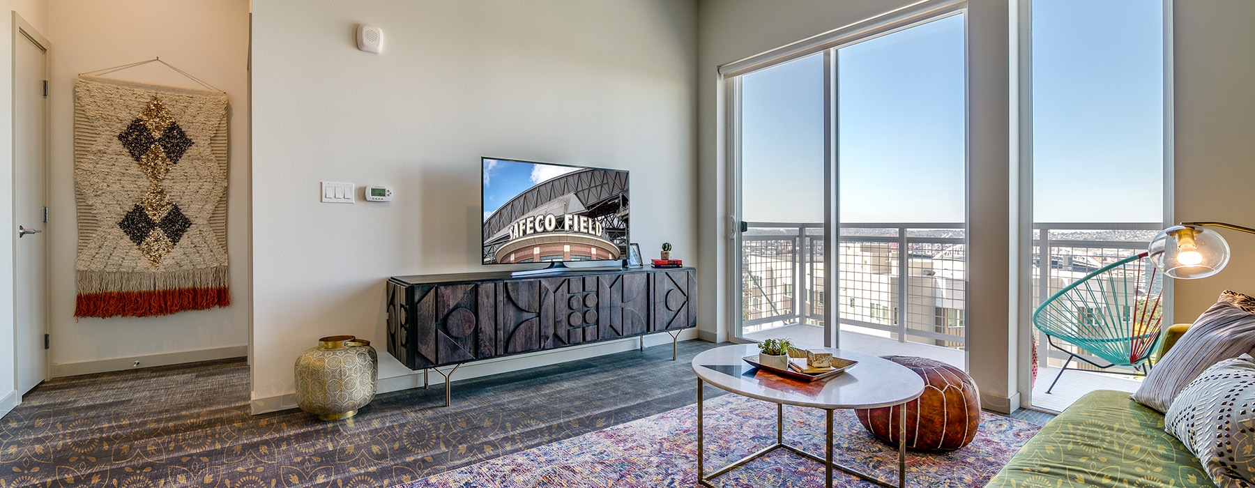 sun filled living room with private balcony access